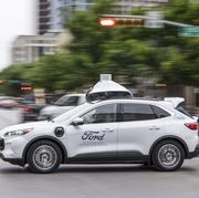 a fifth generation ford autonomous test vehicle drives on a street